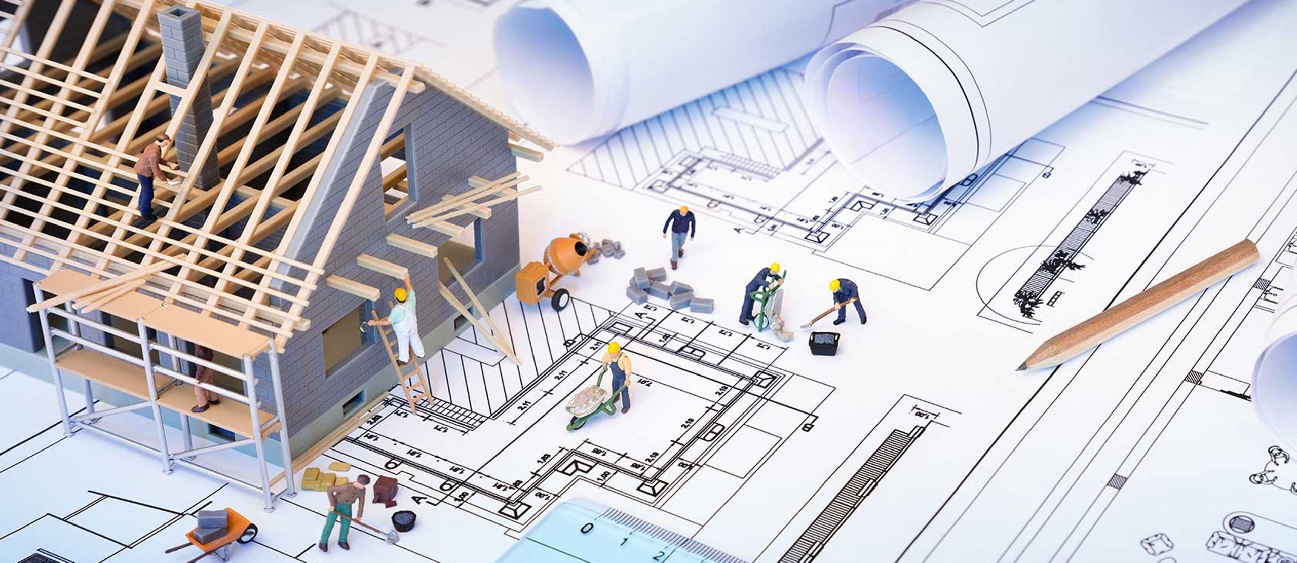 house under construction on blueprints - building project